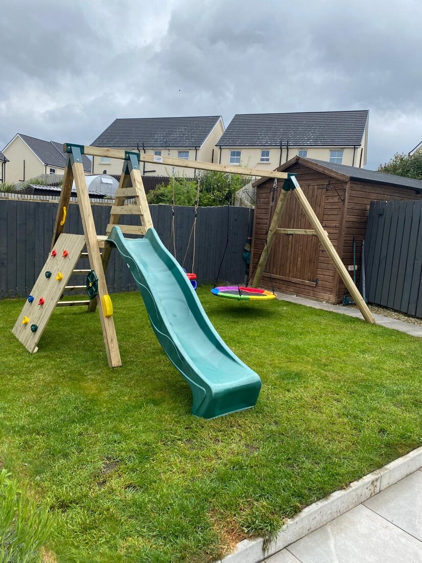 Swing and slide set with rock climb and nest swing